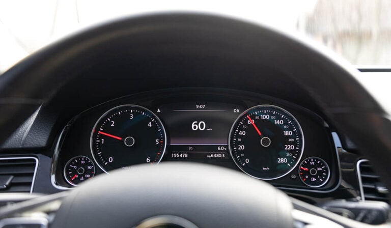 A car speedometer displaying potentially inaccurate or mismatched speed readings.